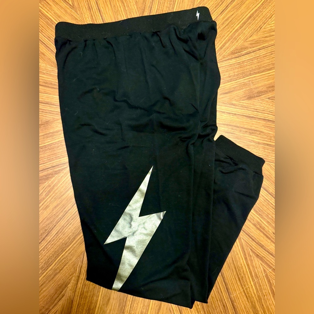 Electric Yoga size M black joggers with silver lightning bolt.